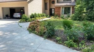 Fort Wayne spring cleanup with fresh mulch landscaping along suburban home driveway.