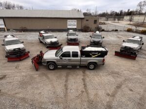 Fort Wayne snow removal fleet with salt trucks and red plows ready for storm.