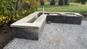 Hardscape installation in progress during backyard renovation project in Fort Wayne