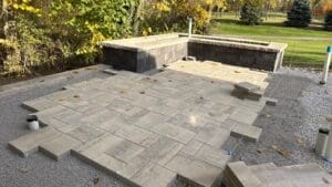 Installing paver patio and hardscape features during backyard renovation in Fort Wayne