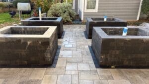 Completed custom backyard patio with modern paver design in Fort Wayne Indiana