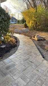 Patio construction in progress with paver installation and grading work in Fort Wayne