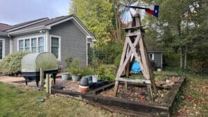 Backyard renovation before image showing outdated landscaping and patio space