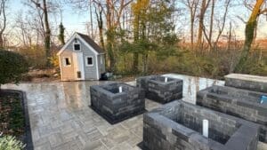 Completed backyard patio installation with landscaping and paver design in Fort Wayne