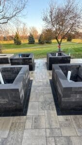 Backyard outdoor living area with completed paver patio and landscaping in Fort Wayne