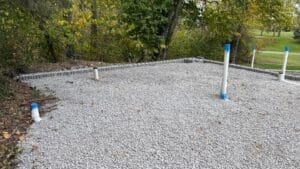 Paver patio installation in progress with base preparation and grading in Fort Wayne