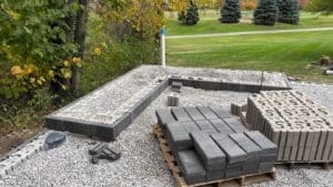 Landscape and patio construction project in progress with new pavers and edging